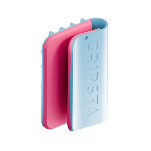 Two interlocking GRIPSTA phone holders in pink and blue, standing upright against a white background.